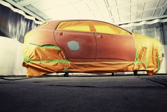 Car masked up in a paint booth, ready for a respray