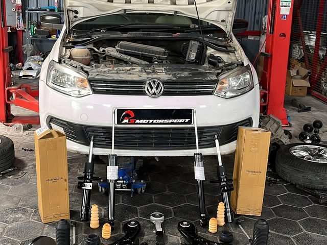 VW Polo on the lift with bonnet up and replacement parts laid out