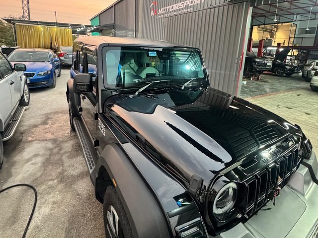Modified Mahindra Thar build outside the workshop at sunset