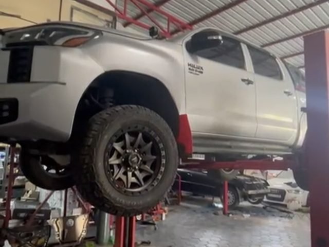 Toyota Hilux up on a lift at AS Motorsport